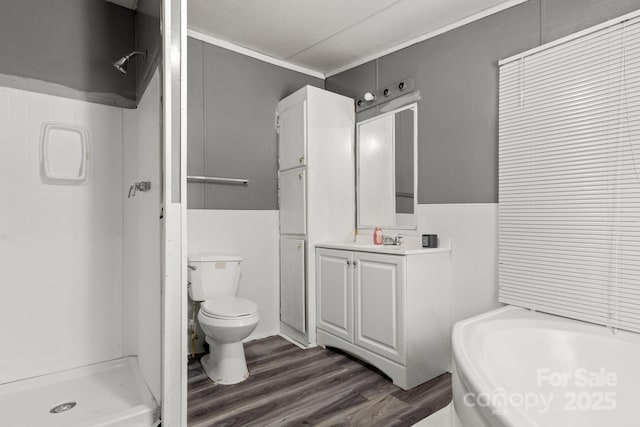 bathroom featuring toilet, a shower, crown molding, vanity, and hardwood / wood-style floors