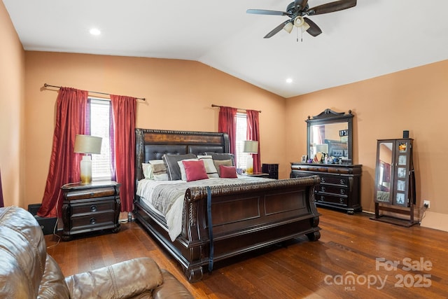 bedroom with multiple windows, lofted ceiling, and dark hardwood / wood-style floors