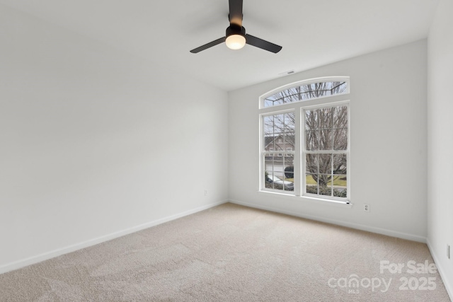 empty room featuring carpet floors, ceiling fan, and plenty of natural light