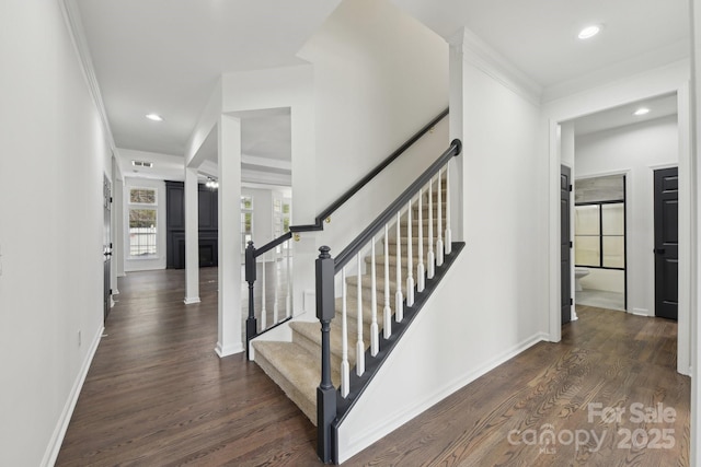 staircase with crown molding and hardwood / wood-style floors