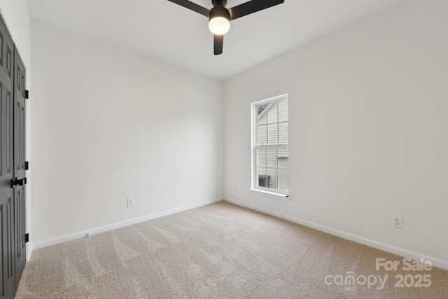 spare room with carpet floors and ceiling fan