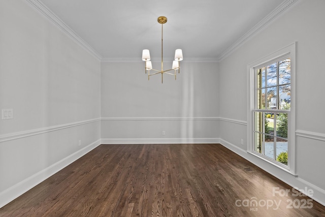 spare room with crown molding, dark hardwood / wood-style flooring, and a chandelier