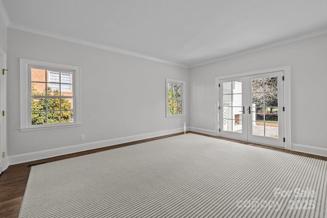 spare room featuring french doors, ornamental molding, a healthy amount of sunlight, and dark hardwood / wood-style floors