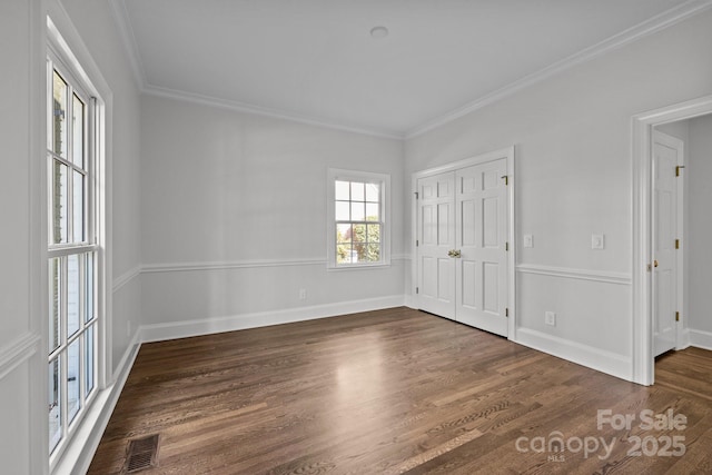 unfurnished room with dark wood-type flooring and ornamental molding