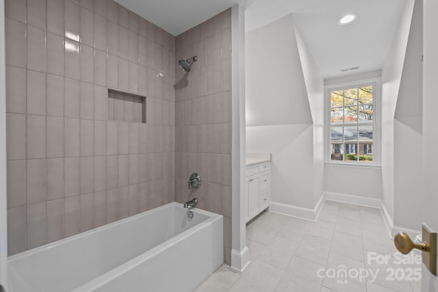 bathroom with vanity, tiled shower / bath combo, and tile patterned floors