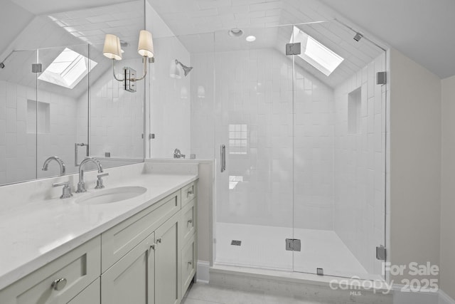 bathroom with vanity, lofted ceiling, and walk in shower