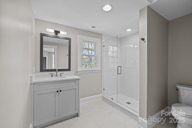 bathroom with walk in shower, vanity, and toilet