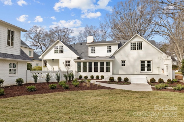 back of property with a lawn and a patio area