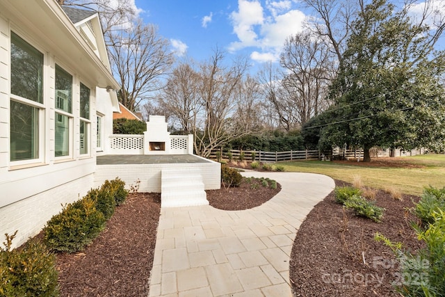 view of yard with a fireplace and a patio area