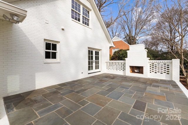 view of patio / terrace with an outdoor fireplace