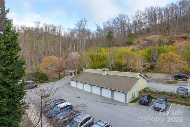 birds eye view of property featuring a view of trees