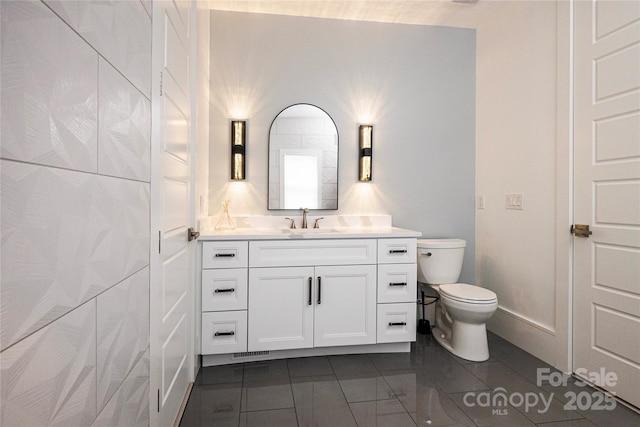 bathroom with tile patterned floors, vanity, and toilet