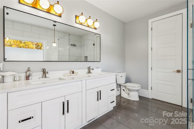 bathroom featuring vanity, tile patterned floors, toilet, and walk in shower