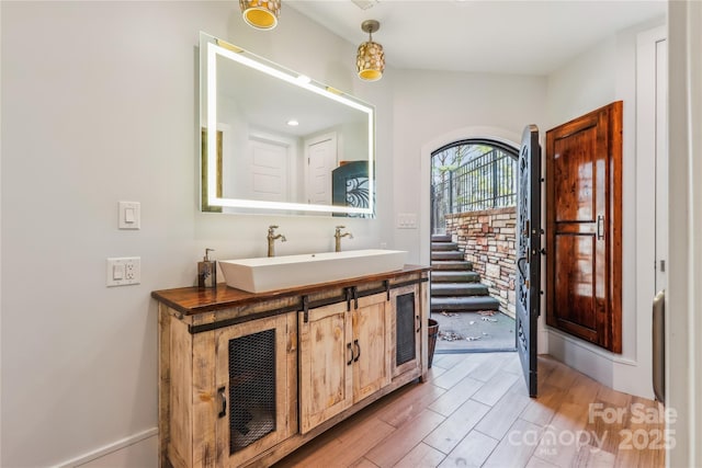 bathroom featuring wood-type flooring and sink