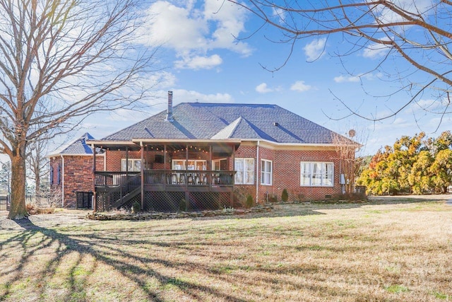 back of property with a yard and a deck