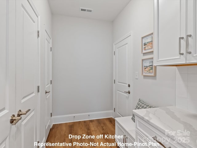 laundry room featuring wood-type flooring