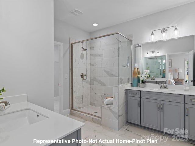 bathroom with vanity and a shower with door