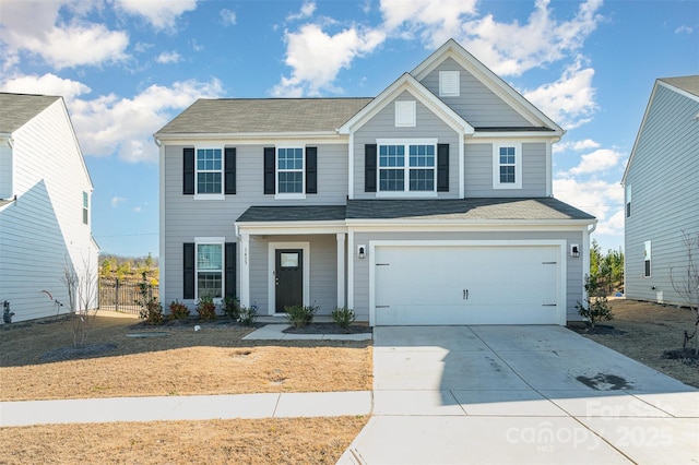 view of front of property featuring a garage, driveway, and fence