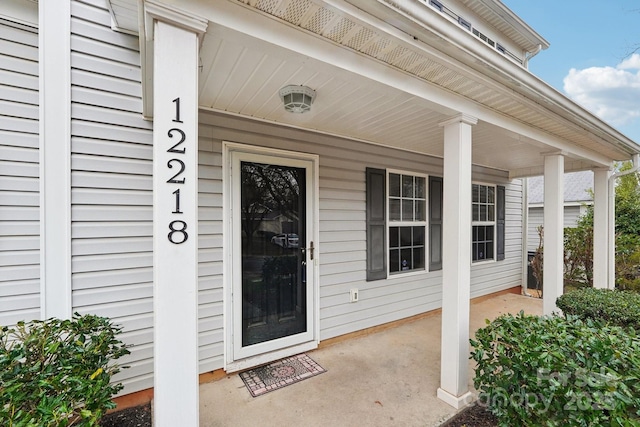 doorway to property featuring covered porch