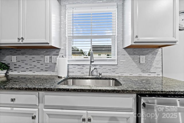 kitchen featuring sink, white cabinetry, tasteful backsplash, dark stone countertops, and beverage cooler