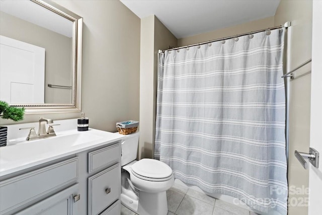 bathroom with vanity, tile patterned floors, and toilet