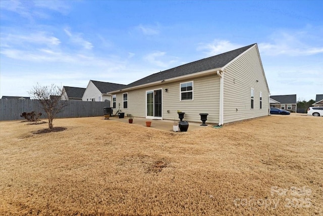 back of property with a patio and a yard