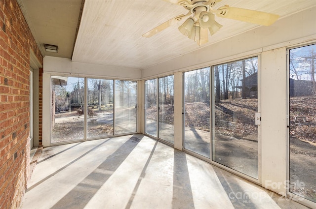 unfurnished sunroom with plenty of natural light and ceiling fan