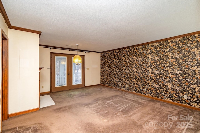 unfurnished room featuring an inviting chandelier, crown molding, carpet floors, and a textured ceiling