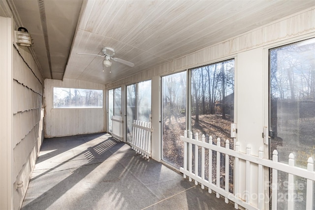 unfurnished sunroom featuring ceiling fan