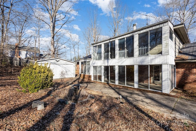 rear view of property with a sunroom