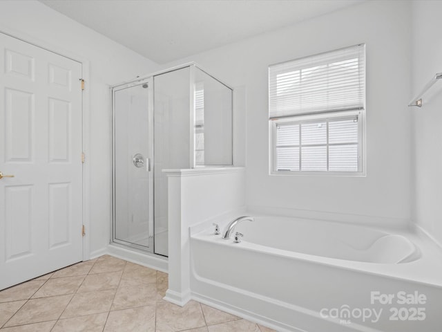 bathroom featuring tile patterned floors and shower with separate bathtub