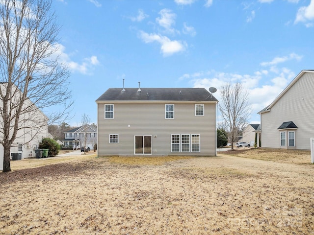 back of house with a lawn