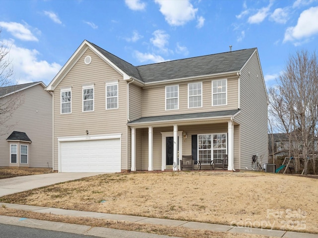 view of property featuring a garage, central AC, and a porch