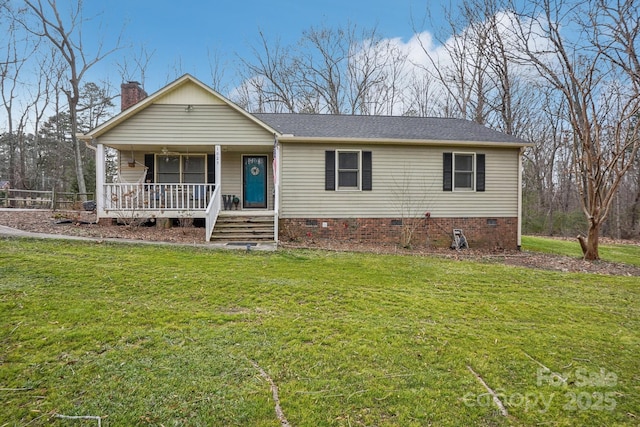 ranch-style home featuring covered porch and a front lawn