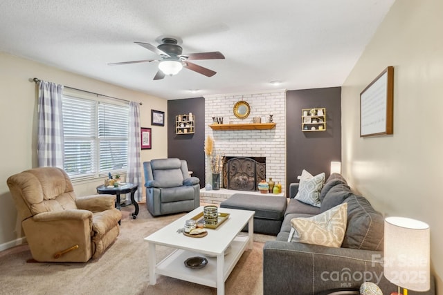 living room featuring a brick fireplace, a textured ceiling, light colored carpet, and ceiling fan