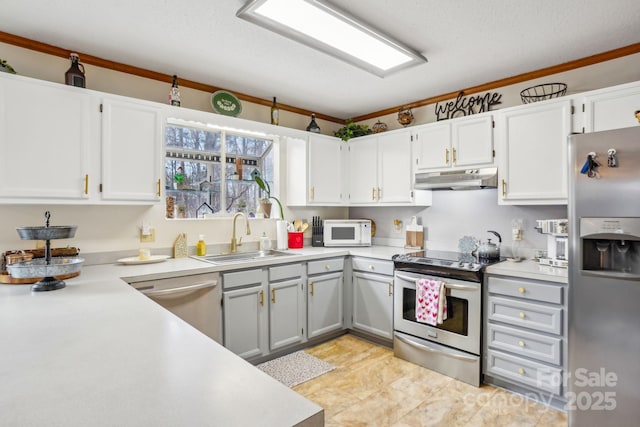 kitchen featuring stainless steel appliances, sink, and white cabinets