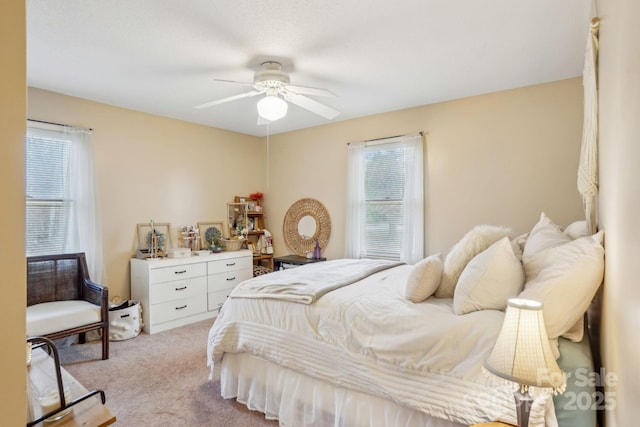 bedroom featuring light carpet and ceiling fan