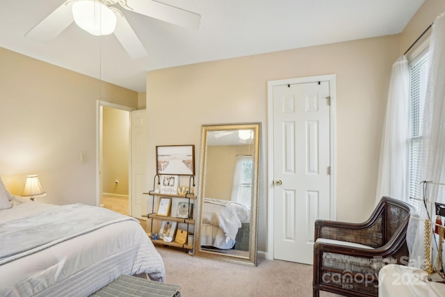 bedroom featuring ceiling fan and light colored carpet