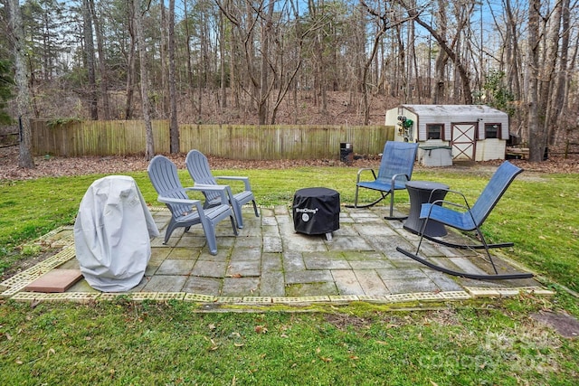 view of yard with a storage unit and a patio area