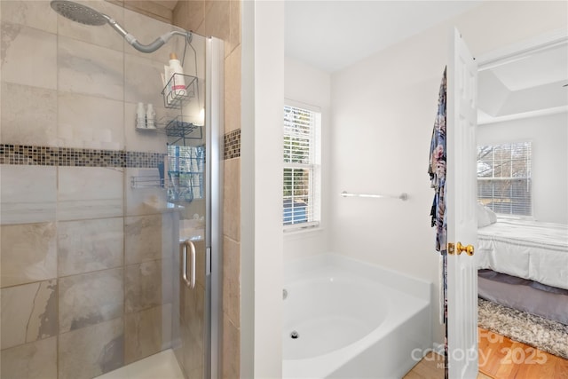 bathroom with shower with separate bathtub