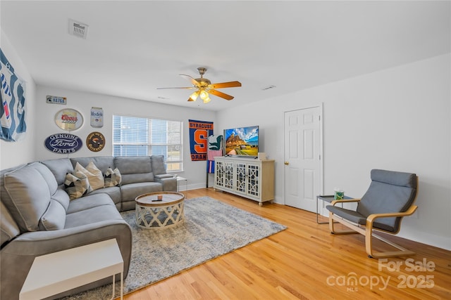 living room featuring hardwood / wood-style flooring and ceiling fan