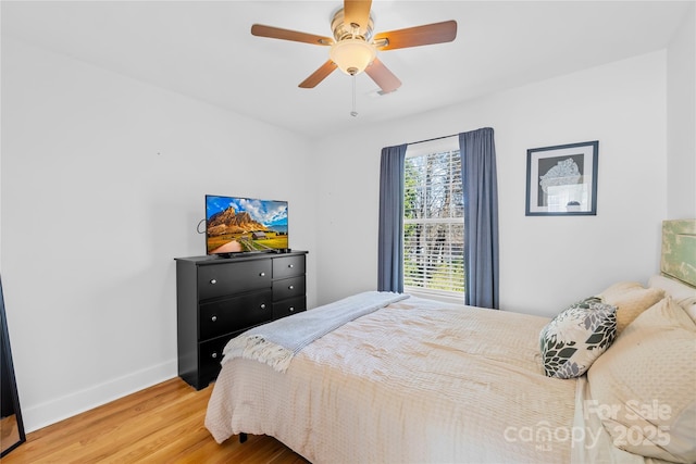 bedroom with ceiling fan and hardwood / wood-style floors