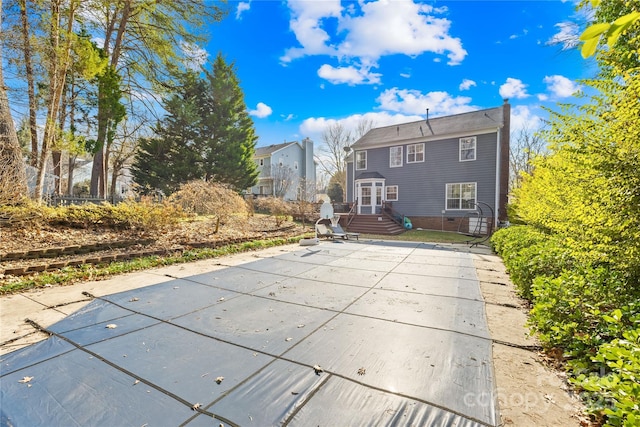 back of house featuring a patio and a covered pool