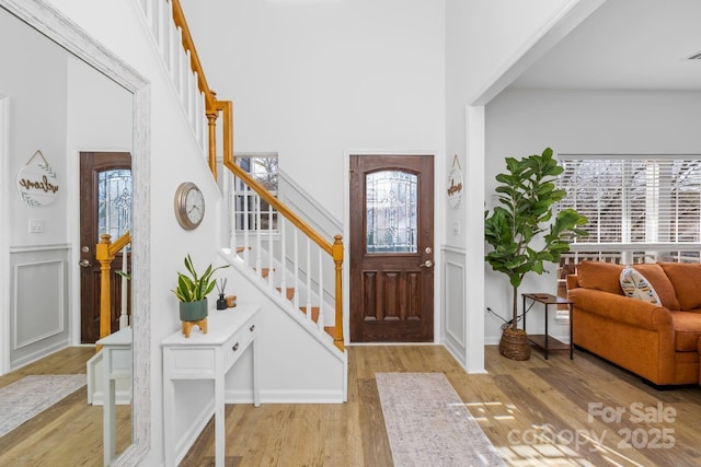 foyer entrance with light hardwood / wood-style floors