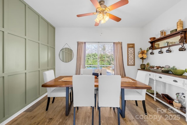 dining space featuring ceiling fan and hardwood / wood-style floors