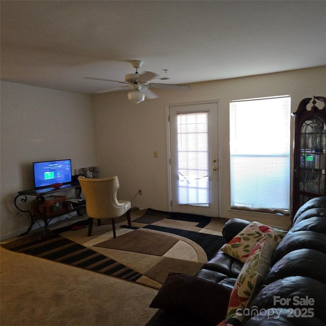 living room featuring carpet floors and ceiling fan