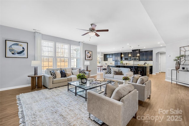 living room featuring hardwood / wood-style flooring and ceiling fan