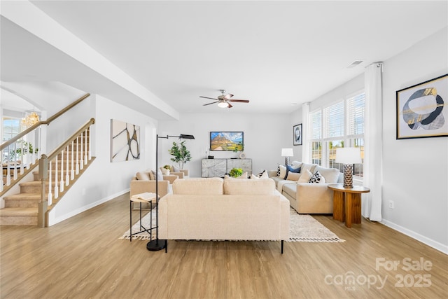 living room featuring light hardwood / wood-style flooring and ceiling fan