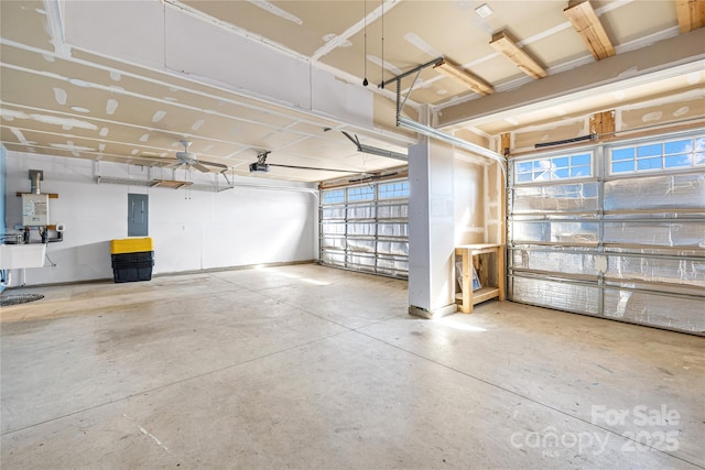 garage with a garage door opener, sink, and electric panel