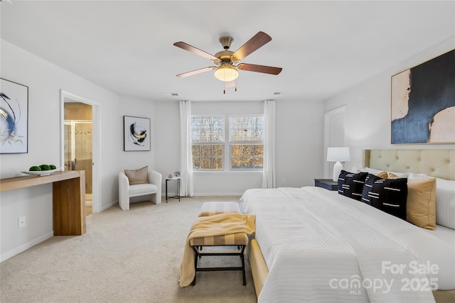 bedroom with light carpet, ceiling fan, and ensuite bathroom